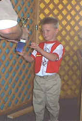 An excited champion receives his trophy.